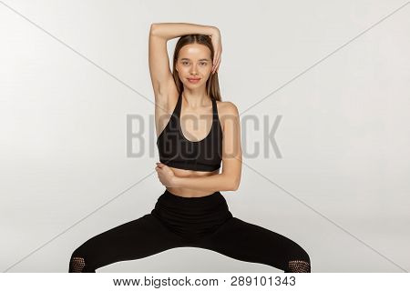 Young Sporty Attractive Woman Practicing Yoga In Chair Pose