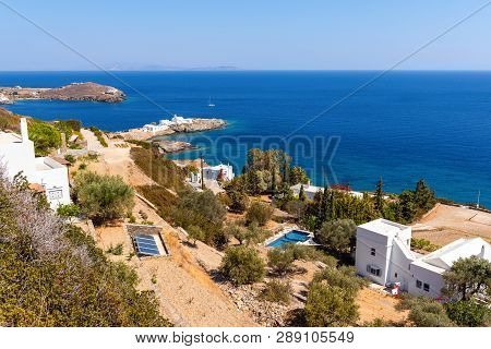 View Of South East Coastline Of Sifnos With Chrisopigi Monastery In Background. Cyclades, Aegean Sea