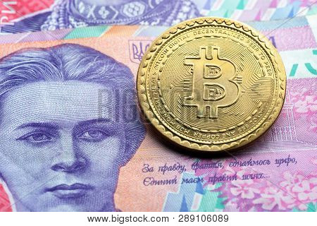 Bitcoin Symbol At Ukrainian Paper Currency Background. Cryptocurrency Technologies Concept. Virtual 