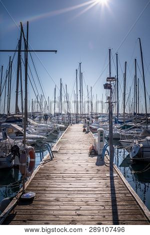 Wooden Pier With Many Boats And Yachts In Marina Harbor Of Holiday Resort Sistiana Near Trieste In I