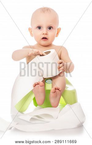 Little Boy Learning How To Use Chamber Pot. Kid Boy Sitting On Chamber Pot With Toilet Paper Rolls I