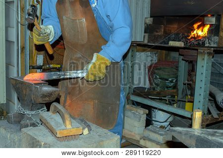 The Bladesmith Forges A Knife In The Blacksmith Shop In Missouri.
