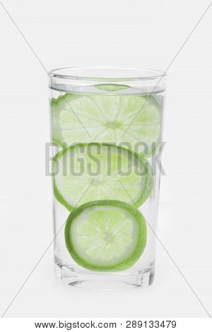 Glass With Water And Lemon Isolated On White Background