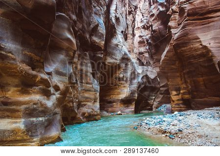 River Canyon Of Wadi Mujib In Amazing Golden Light Colors. Wadi Mujib Is Located In Area Of Dead Sea