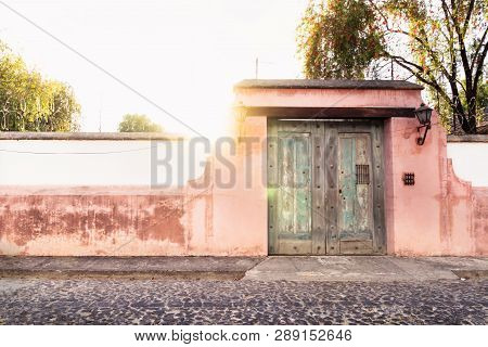 Finca Port In Colonial Style With Rose Wall And Sunbeam In Antigua, Guatemala