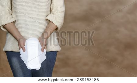 Young Woman Holding A Menstrual Pad. Woman Holding A Daily Sanitary Pad. Menstruation Or Period Days