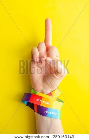 Women's Hand Wrapped In Rainbow Ribbon Lgbt Symbol Shows Off The Middle Finger, The Concept Of Confr