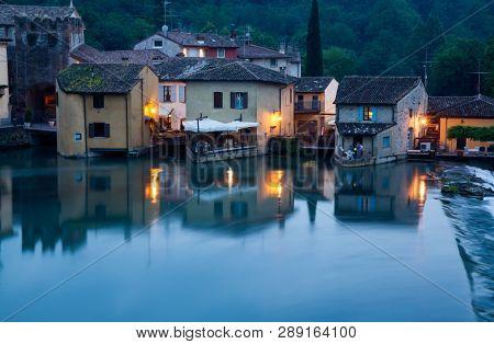 Panoramic night view of Borghetto (Valeggio sul Mincio, Verona) from the bridge on the river Mincio