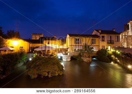 Panoramic night view of Borghetto (Valeggio sul Mincio, Verona) from the bridge on the river Mincio
