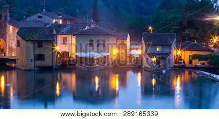 Panoramic night view of Borghetto (Valeggio sul Mincio, Verona) from the bridge on the river Mincio