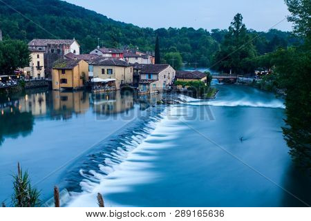 Panoramic night view of Borghetto (Valeggio sul Mincio, Verona) from the bridge on the river Mincio