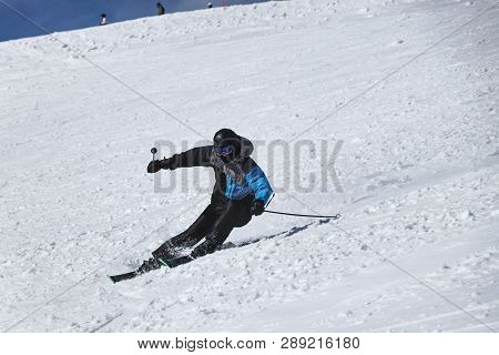 A Male Skier Skiing Downhill In Chopok, Slovakia. Carve Position. Turn Left. Freeride. Dificult Posi