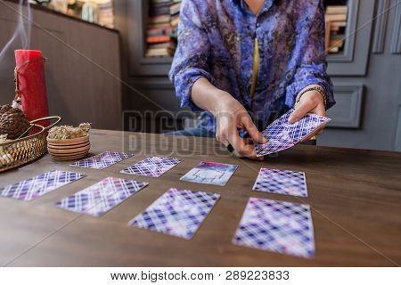 Close Up Of Tarot Cards In Female Hands