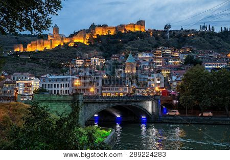 Tbilisi, Georgia - September 22, 2018: Colorful Evening View Of Old Town And The Illuminated Narikal