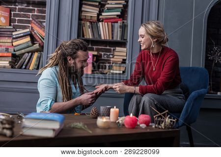 Attractive Positive Young Woman Visiting A Chiromancer