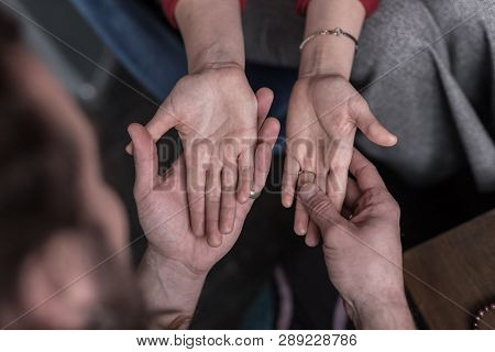 Top View Of Female Palms In Chiromancers Hands
