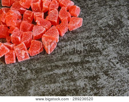 A Bunch Of Red Candied Fruits. Background Gray Loft.