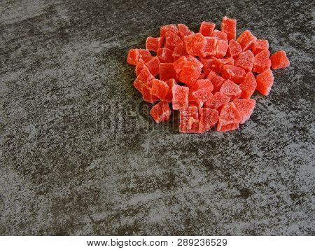 A Bunch Of Red Candied Fruits. Background Gray Loft.