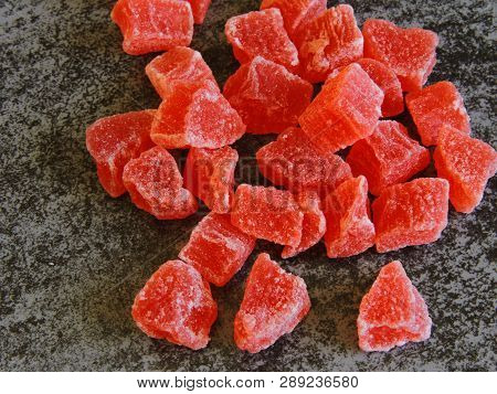 A Bunch Of Red Candied Fruits. Background Gray Loft.