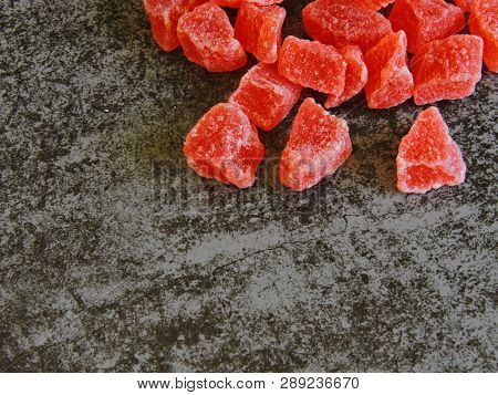 A Bunch Of Red Candied Fruits. Background Gray Loft.