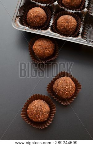 Chocolate Pralines Over Black Background. Top View.