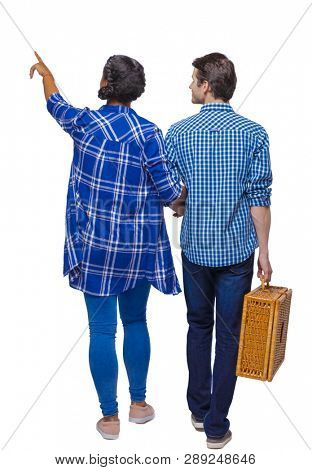 Back view of interracial going couple with a picnic bag who points somewhere. Rear view people collection. backside view of person. Isolated over white background. African American goes showing a guy