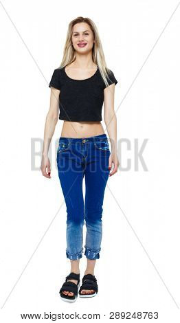 Front view of walking woman. beautiful girl in motion. frontside view of person. people collection. Isolated over white. Smiling girl in a short t-shirt.