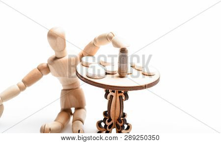 Health Care And Medical Treatment. Pills On Tiny Wooden Table. Medication Regimen. Human Wooden Dumm