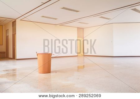 Water Leak Drop Interior Office Building In Red Bucket From Ceiling And Flow On Terrazzo Floor