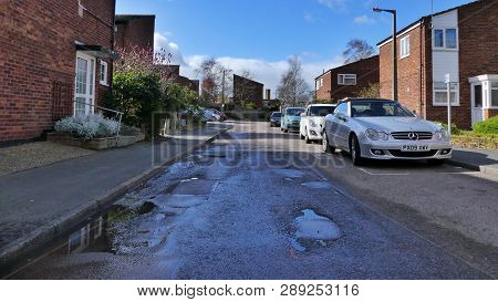 Harlow, England - 13 March 2019. A Potholes Road Leading Through A Housing Estate In The Staple Tye 