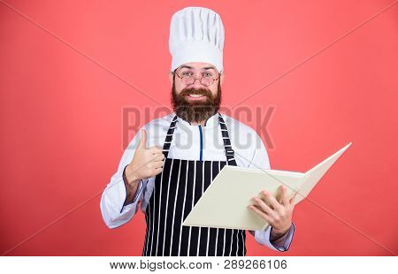 Improve Cooking Skill. Book Recipes. According To Recipe. Man Bearded Chef Cooking Food. Culinary Ar