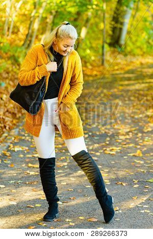 Woman Wearing Long Orange Warm Cardigan Sweater, White Tight Trousers Pants, High Knee Black Shoes A