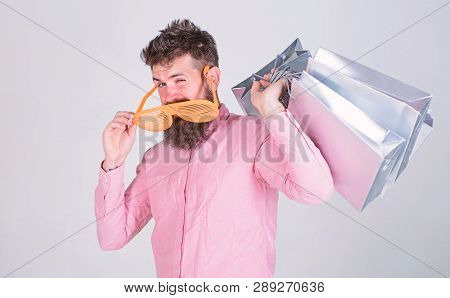 How To Get Ready For Your Next Vacation. Man Bearded Hipster Wear Sunglasses Hold Bunch Shopping Bag