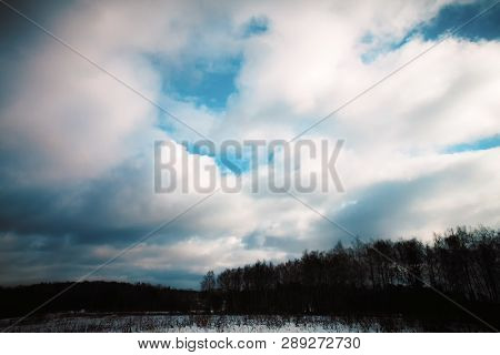 Clouds Over Dark Trees. The Nature Of Russia. Landscapes Of Russia. White Clouds In The Blue Sky.