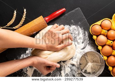 Food Preparation Concept Over Head Shot Kneading Dough For Bakery, Pizza Or Pasta On Black Backgroun