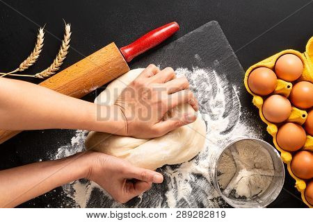 Food Preparation Concept Over Head Shot Kneading Dough For Bakery, Pizza Or Pasta On Black Backgroun
