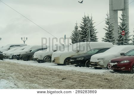 Cars Under Snow In The Parking Lot