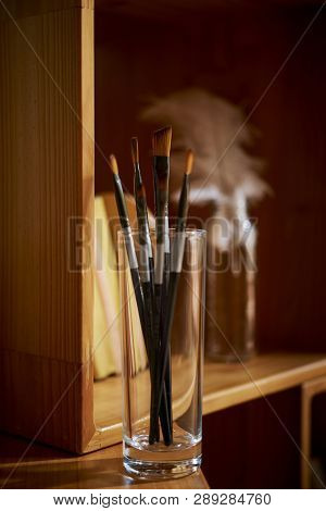 Tall Glass With Pain Brushed For Watercolor In Apartment Of Creative Person