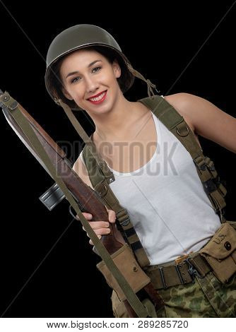 A Pretty Young Woman Dressed In Wwii American Military Uniform With Helmet And Rifle