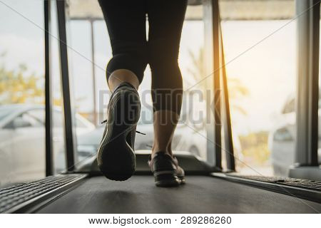 Female Muscular Feet In Sneakers Running On The Treadmill At The Gym, Lower Body At Legs Part Of Fit