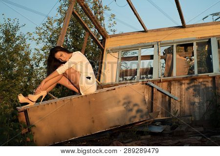 Fashion Portrait Of Young Woman, In An Old House, In Ruin, Sitting