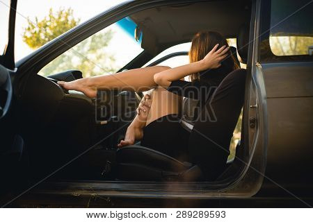 Beautiful Girl In Car Put Her Legs On Panel