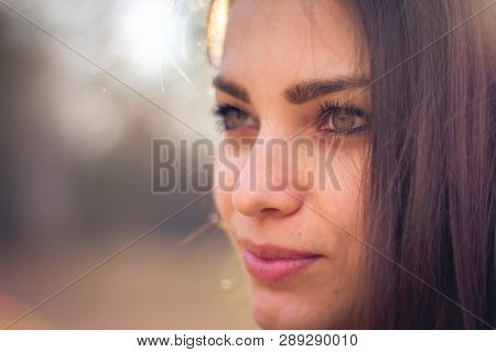 A Beautiful Brunette Girl Posing In A Field On Autumn. Art Photo.