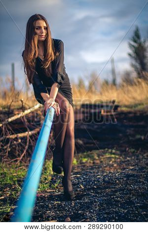 A Beautiful Brunette Girl Sitting On Stairs. Autumn. Art Photo.