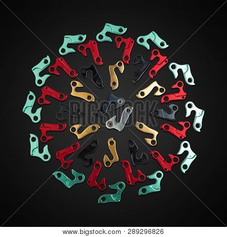 Laid Out Mandala-shaped Hangers For Derailleur Bike On Black Background. Bicycle Frame Rear Deraille