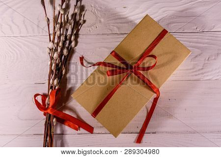 Pussywillow Bouquet And Cardboard Gift Box On White Wooden Table. Top View