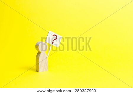 Wooden Human Figurine With A Question Mark. Minimalism. Asking A Question, Searching For Truth And D