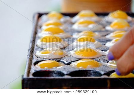 Close Up Baked Quail Eggs In A Black Hot Oven And Selling At Street Market In Thailand