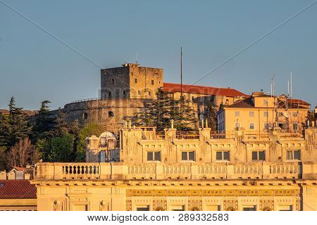 View From Molo Audace To Hill With Castle Castello Di San Giusto On Sunset In Trieste, Italy