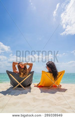 Two Women enjoying their holidays on a transat at the tropical beach in Thailand